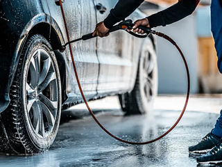 The method of using a high pressure washer to clean cars